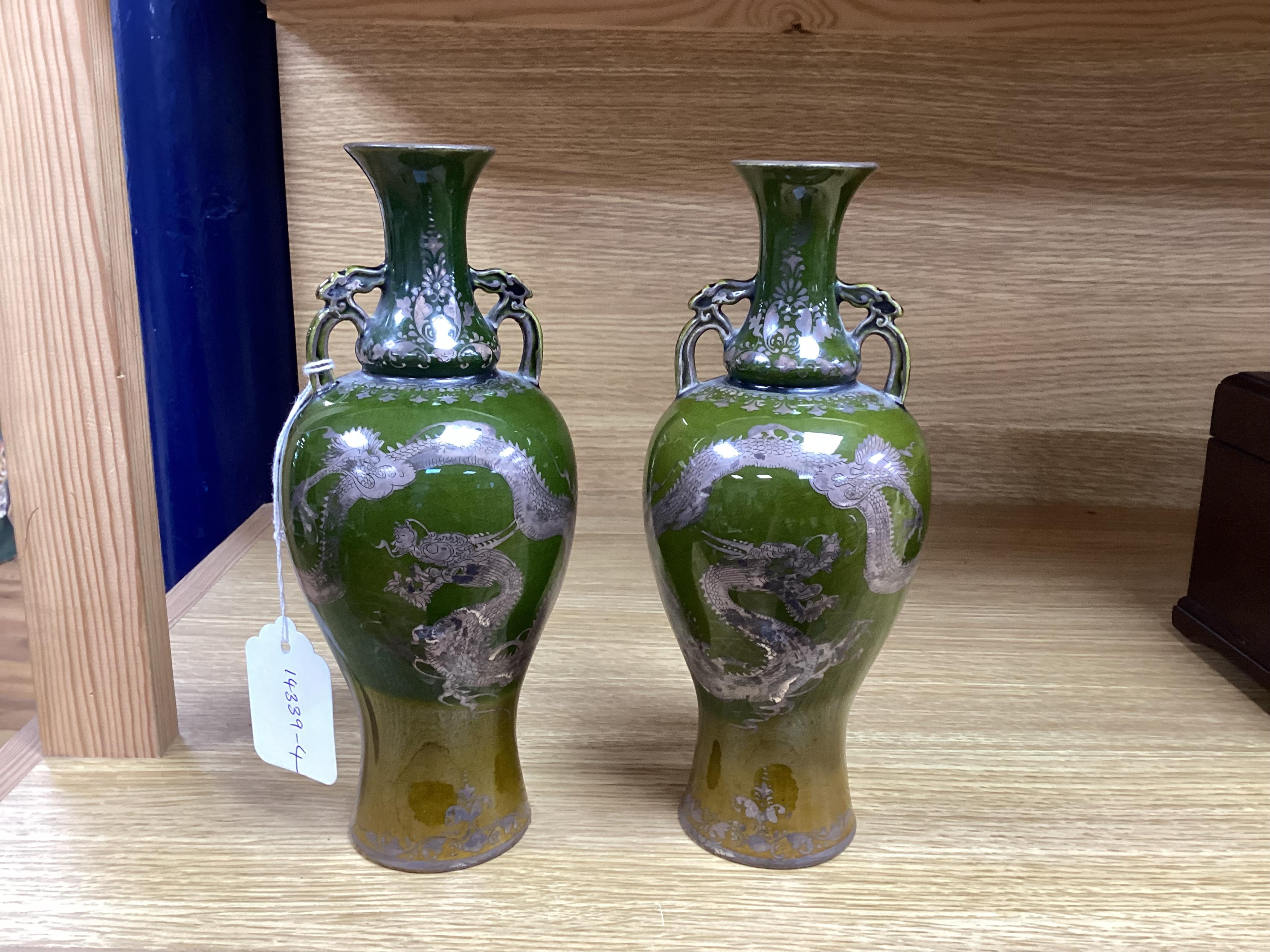 A pair of Japanese silver lustre decorated ‘dragon’ vases, 22.5cm